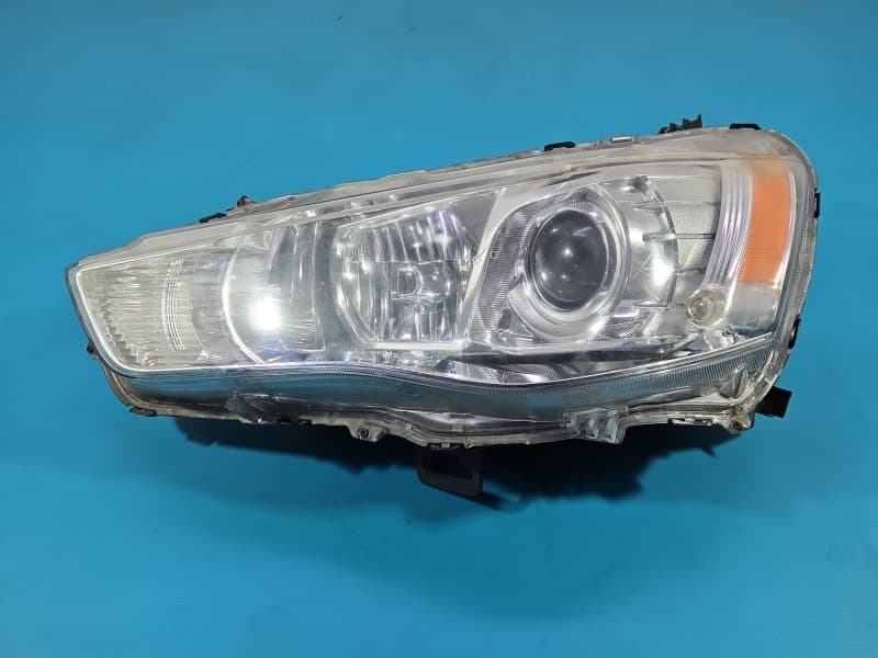 Reflektor lewy lampa przód Mitsubishi Outlander II 06-13 EUROPA